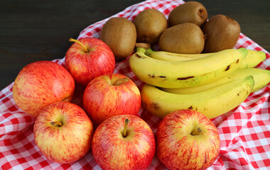 Heap of Assorted Fresh Ripe Tasty Fruits on Checkered Cloth for the Concept of WELLNESS
