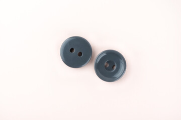 Two gray plastic buttons on both sides.