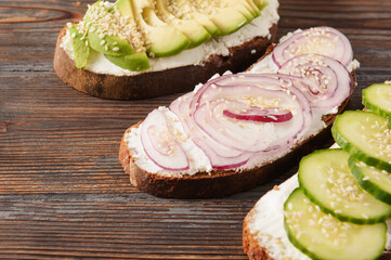 sandwiches with , cucumber , cheese and avocado slices, red onion