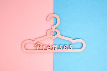 Colorful empty hangers on colored background.