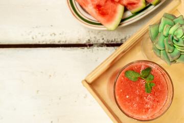 Watermelon drink and abuza slices. Watermelon and gin punch on the table in a summer bar, party. Summer refreshing drink. Copy space.
