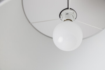 Energy saving light bulb ball in ceiling lamp at home. Power energy saving with LED lamp