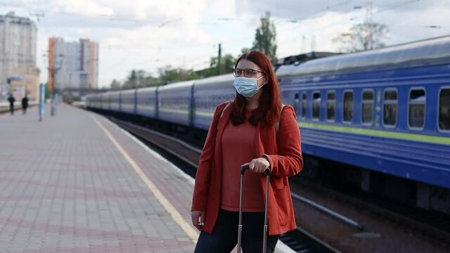 Portrait of Caucasian tourist woman protective face mask outdoors at the train station