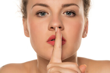 Naklejka premium woman with a finger in front of her lips