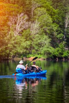 Two Unidentifiable People In A Canoe Kayak