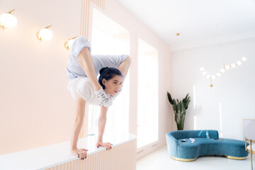 Flexible girl practice stretching and handstand at home. concept of quarantine time during self...