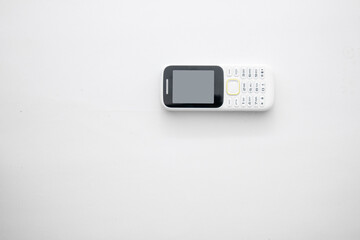 White handphone on white board, White table