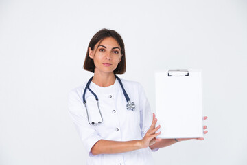 Female doctor in lab coat on white background isolated, confident smile hold white paper blank with empty space