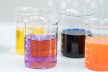 Close-up and selective focus shoot of a microscope, medical test tubes with liquid, and other modern laboratory equipment in a laboratory room. Education stock photo