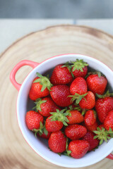 Bowl of fresh strawberries on a table. Top view.