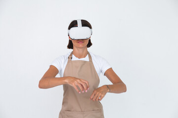 Housewife in apron isolated on white background in vr glasses cooking making dinner play games