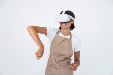 Housewife in apron isolated on white background in vr glasses cooking making dinner play games