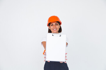 Pretty woman engineer in building protective helmet on white background smile hold white paper blank with empty space