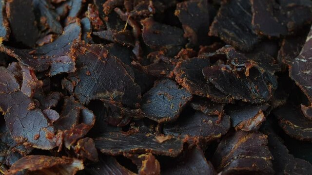 Dried Beef Jerky snack background. rotating video