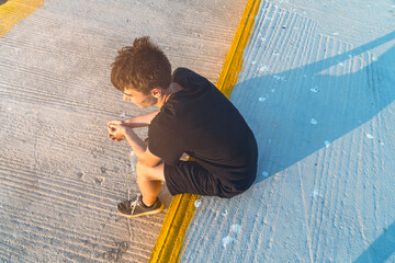 portrait of a pensive teenager photographed from above and behind
