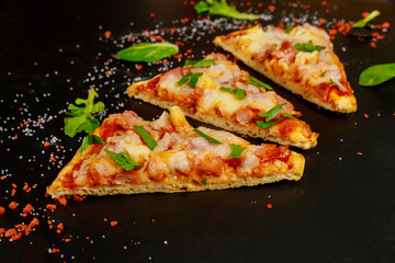 Sliced pizza with tomato sauce, ham and mozzarella .