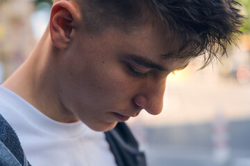 closeup of a pensive teenager looking down