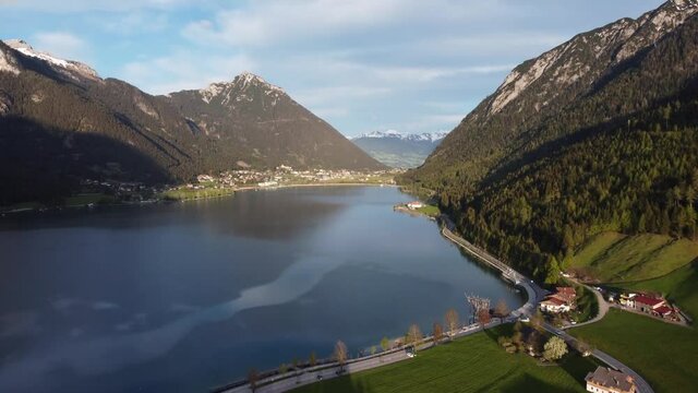 Achen lake and Alps aerial view during sunset. Maurach village at the foot of big mountain and Rofan region.