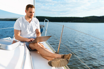 Successful Man Using Laptop Sitting On Yacht Deck Working Online