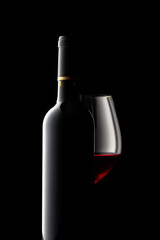 Bottle and glass of red wine.