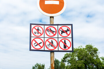 information board with forbidding signs at the entrance to the playground in the recreation park