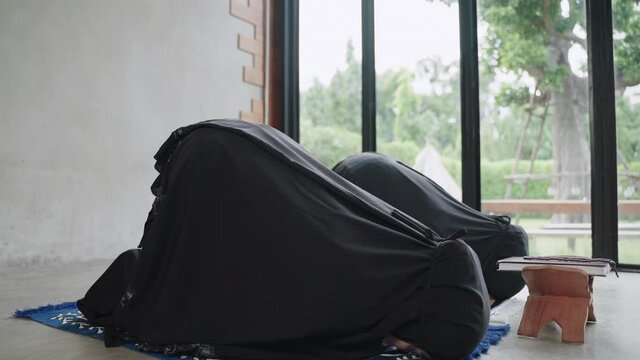 Young Muslim women are doing prayers for the blessing of God Allah.
