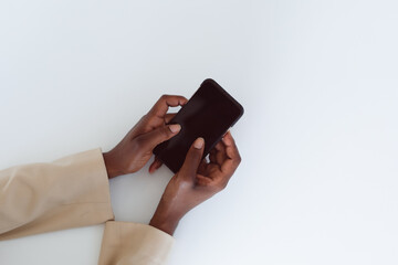 Hand of african american woman holding smartphone with copy space on screen