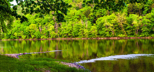Rocks protruding into the Allegheny river in Althom, Pennsylvania, USA in the north west corner of...