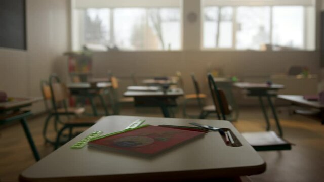 Classroom with desks and chairs. Interior of school room with chalkboard