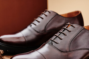 Fototapeta na wymiar Brown leather men's shoes made of genuine leather in classic style close-up. High quality photo