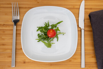 little portion salad on a plate