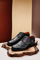 Black leather men's shoes made of genuine leather in classic style on a wooden cut. Close-up. High quality photo