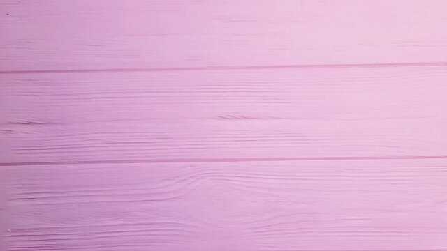 Animated Paper hearts fly out of pink envelope on wooden pink background. Valentines day concept. Stop motion animation 4k video