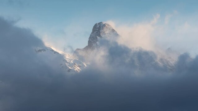 The Olan peak in the Ecrins National Park with passing clouds (time-lapse) at Sunrise. Major peak of the GR54 Ecrins Massif hiking tour in the Valgaudemar Valley. Hautes-Alpes, French Alps, France