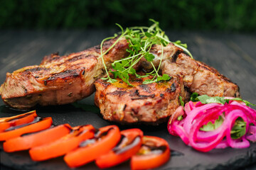 beef steak with spices and vegetables, on a wooden table
