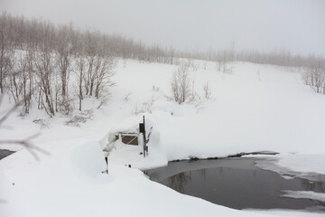Whinter river in snow, branch in hoar