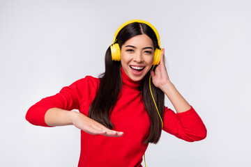 Photo of young good looking smiling cheerful girl in headphones funky dancing isolated on grey color background