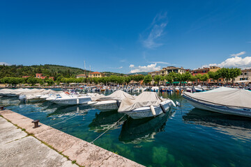 Port of the small town of Garda with many boats moored, tourist resort on the coast of Lake Garda (Lago di Garda). Verona province, Veneto, Italy, southern Europe.