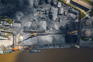 Loading and unloading coal on ship terminal sea cargo port, industrial background, aerial top view - obrazy, fototapety, plakaty