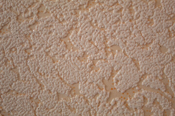 beige textured background in the form of decorative putty