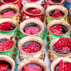 pots with water and rose petals, Indian traditions and holidays