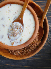 buckwheat porridge with milk on a wooden background