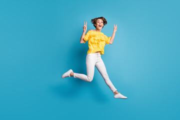 Fototapeta na wymiar Full length profile side photo of active excited girl jump up air make v-signs isolated on blue color background