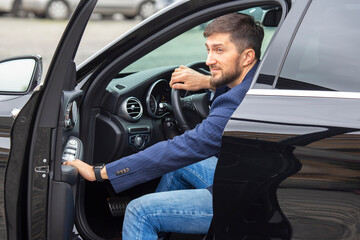 Fototapeta na wymiar successful businessman is driving an expensive car