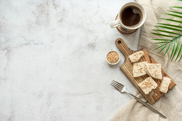 Sliced tahini halva on a wooden board, flat lay