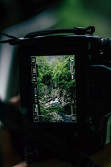 camera photographing a waterfall