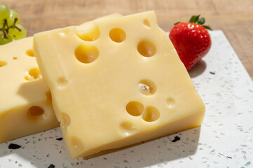 Cheese collection, blocks of French emmentaler cheese with many round holes made from cow milk