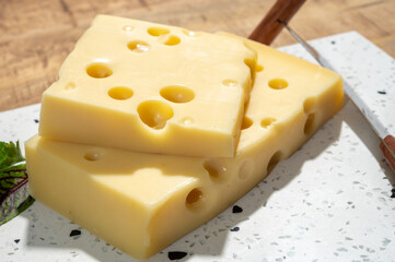 Cheese collection, blocks of French emmentaler cheese with many round holes made from cow milk