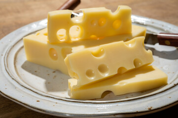 Cheese collection, blocks of French emmentaler cheese with many round holes made from cow milk