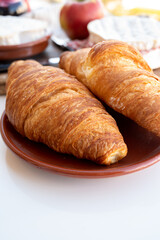French breakfast with fresh baked croissants and cheeses from Normandy, camembert and neufchatel served outdoor with nice city view